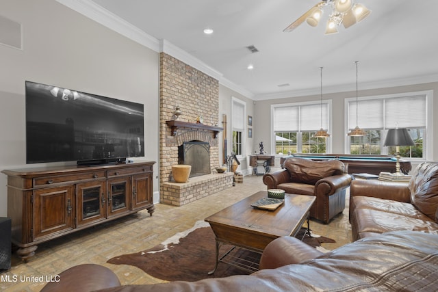 living room featuring crown molding, pool table, a fireplace, and ceiling fan