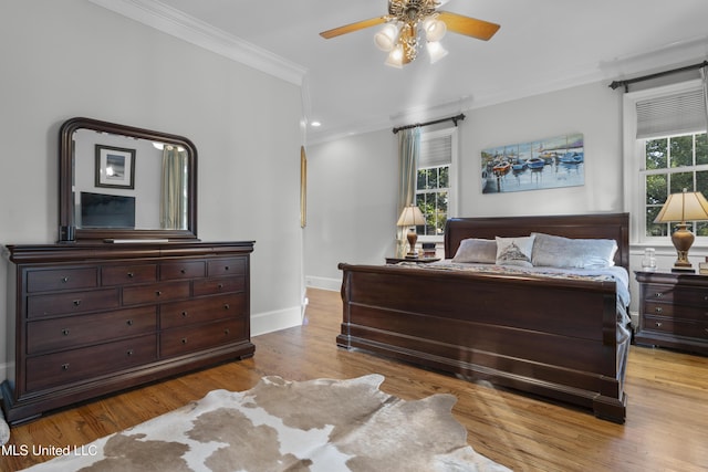 bedroom featuring crown molding, ceiling fan, and light wood-type flooring