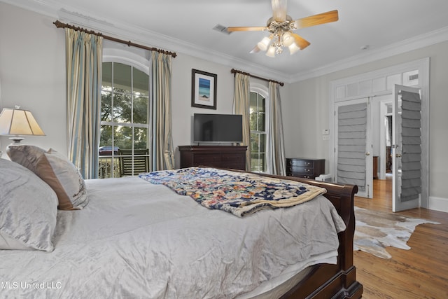 bedroom with crown molding, ceiling fan, hardwood / wood-style floors, and access to outside