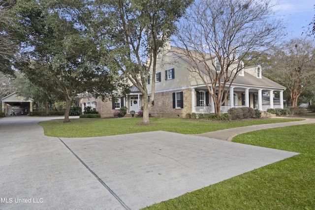 view of front of house with covered porch and a front lawn