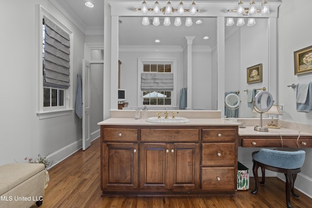 bathroom featuring crown molding, vanity, and hardwood / wood-style flooring