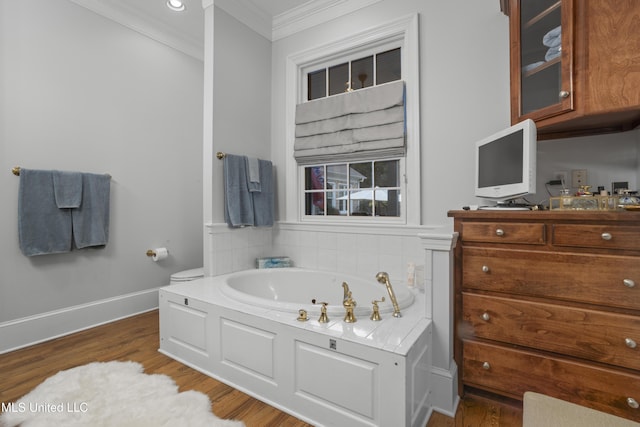 bathroom featuring hardwood / wood-style flooring, ornamental molding, and a tub