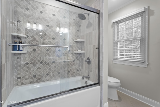 bathroom with tile patterned flooring, ornamental molding, shower / bath combination with glass door, and toilet