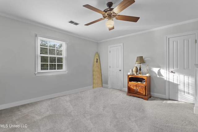 unfurnished bedroom featuring ornamental molding, light colored carpet, and ceiling fan