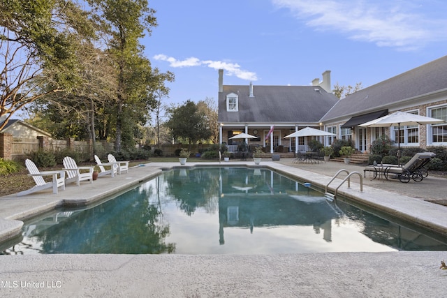 view of swimming pool with a patio