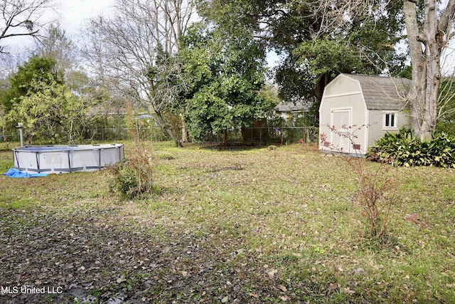 view of yard with a shed and a fenced in pool