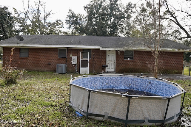 back of house with central AC unit