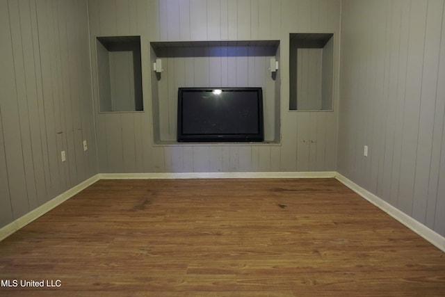 empty room featuring wood walls