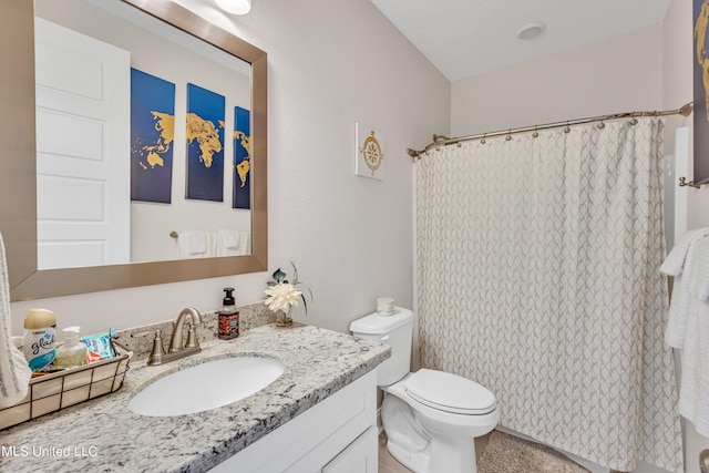 bathroom featuring vanity, toilet, and a shower with shower curtain