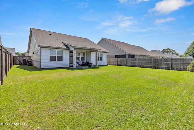 rear view of property featuring a patio and a lawn