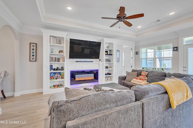 living room featuring crown molding, a textured ceiling, light hardwood / wood-style flooring, and ceiling fan