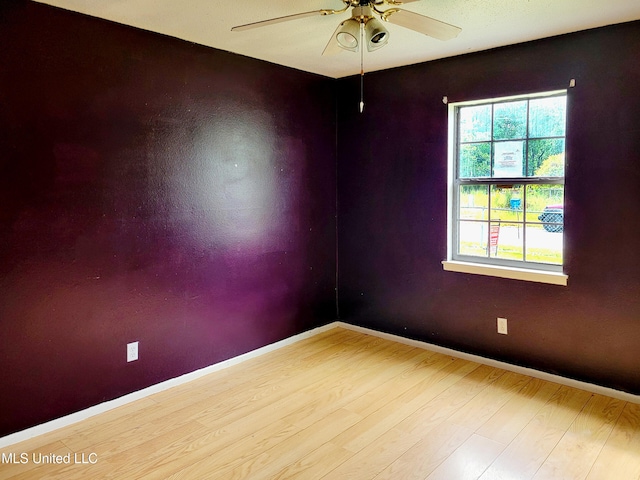 spare room featuring light hardwood / wood-style floors and ceiling fan