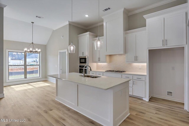 kitchen with visible vents, a sink, white cabinetry, and stainless steel appliances