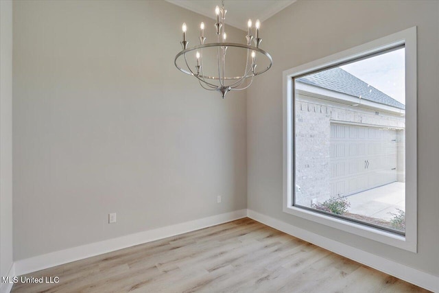 unfurnished dining area with baseboards, wood finished floors, and a notable chandelier