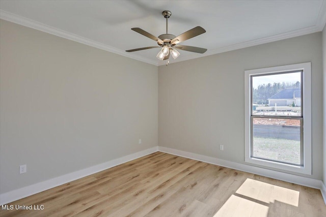 spare room featuring ornamental molding, a wealth of natural light, and light wood-style floors