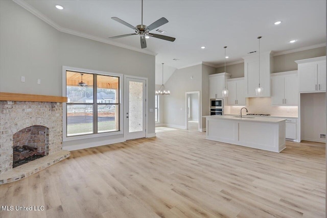 unfurnished living room with crown molding, recessed lighting, and a sink