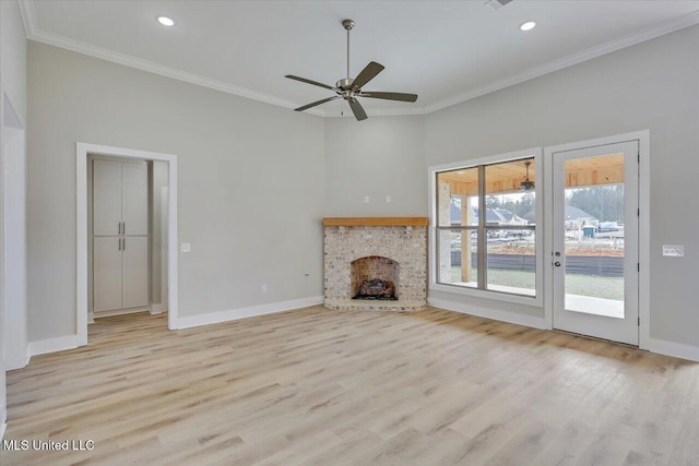 unfurnished living room featuring baseboards, ornamental molding, wood finished floors, and a fireplace