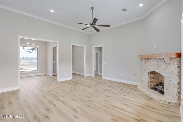 unfurnished living room with baseboards, ornamental molding, light wood finished floors, and a fireplace