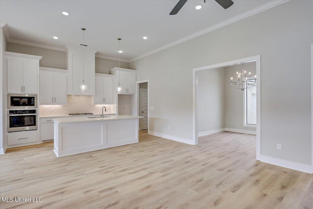 kitchen featuring light countertops, white cabinetry, tasteful backsplash, a sink, and stainless steel appliances