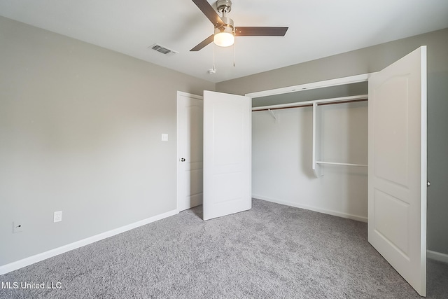 unfurnished bedroom with ceiling fan, a closet, and carpet