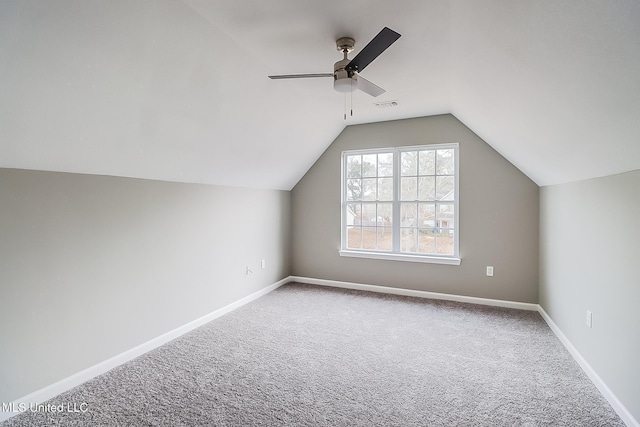 bonus room with vaulted ceiling, ceiling fan, and carpet flooring