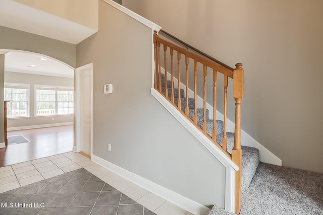 stairway with tile patterned floors