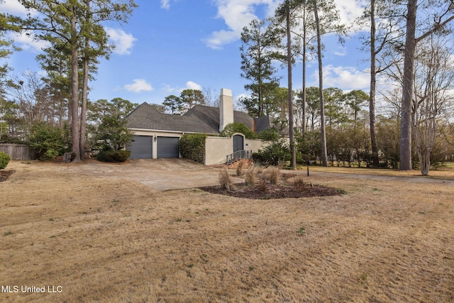 view of home's exterior with a yard and a garage