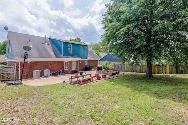 1826 Towson Ln, Horn Lake, MS 38637 - rear view of house featuring a patio area, central AC, brick siding, and a vegetable garden