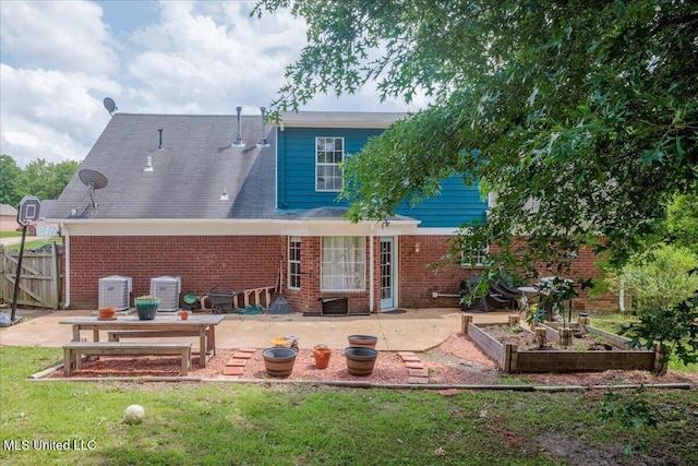 1826 Towson Ln, Horn Lake, MS 38637 - rear view of house featuring a patio area, brick siding, and a garden