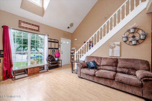 1826 Towson Ln, Horn Lake, MS 38637 - living area with high vaulted ceiling, stairs, wood finished floors, and a skylight