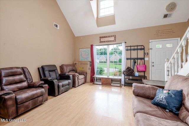 1826 Towson Ln, Horn Lake, MS 38637 - living room featuring high vaulted ceiling, wood finished floors, and stairway