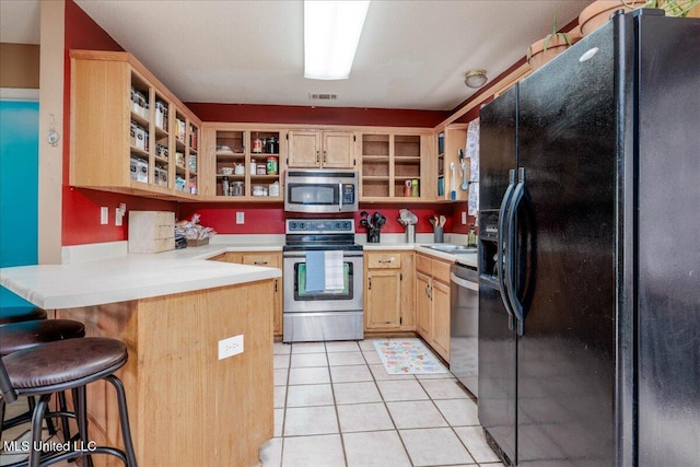 1826 Towson Ln, Horn Lake, MS 38637 - kitchen with stainless steel appliances, open shelves, a peninsula, light countertops, and light brown cabinets