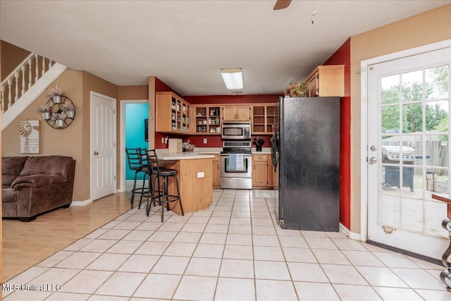 1826 Towson Ln, Horn Lake, MS 38637 - kitchen with stainless steel appliances, a peninsula, glass insert cabinets, light countertops, and open floor plan