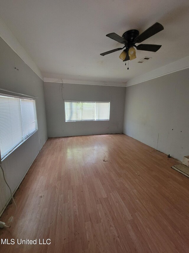 spare room featuring light wood finished floors and ceiling fan