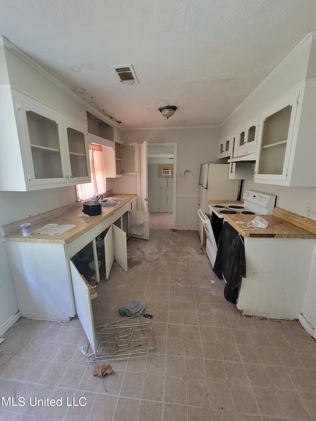 kitchen featuring white electric range, white cabinets, crown molding, and visible vents