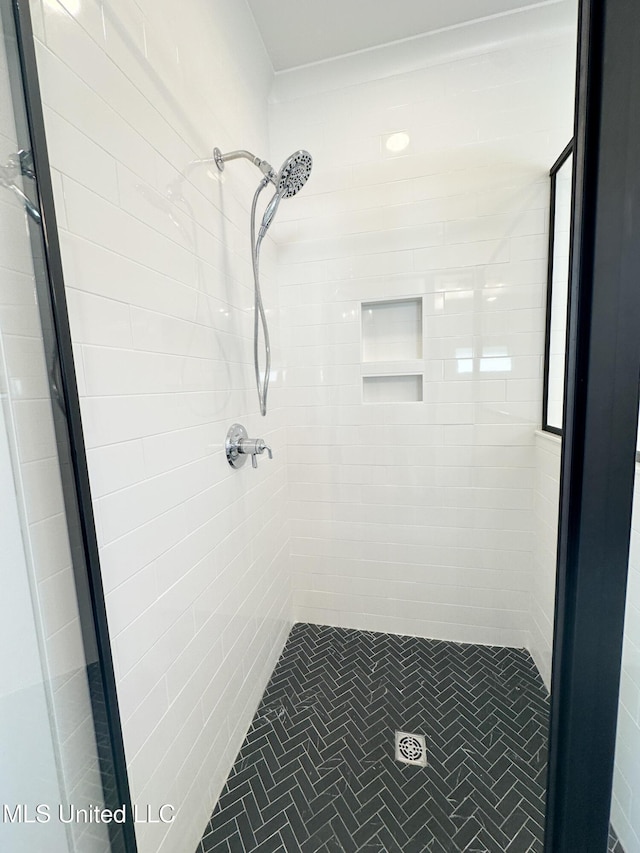 bathroom with a tile shower