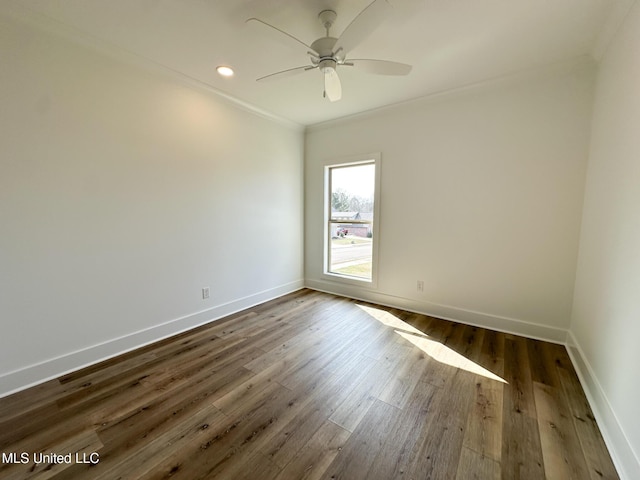 spare room with crown molding, ceiling fan, and dark hardwood / wood-style floors