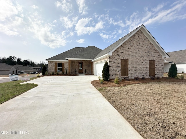 view of front of home featuring a garage and a front lawn