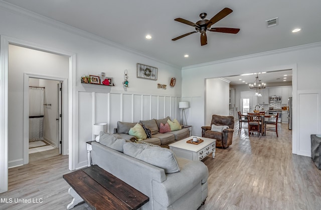 living room featuring ornamental molding and light hardwood / wood-style floors