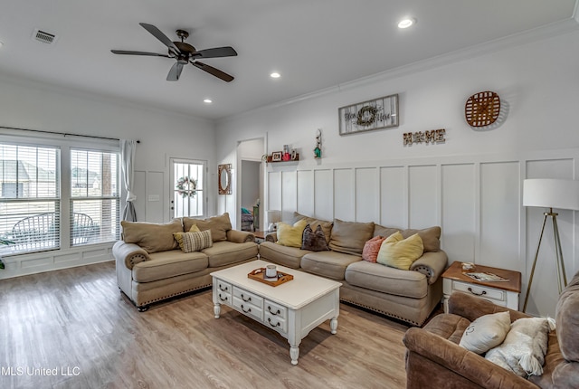 living room featuring crown molding, ceiling fan, and light hardwood / wood-style flooring