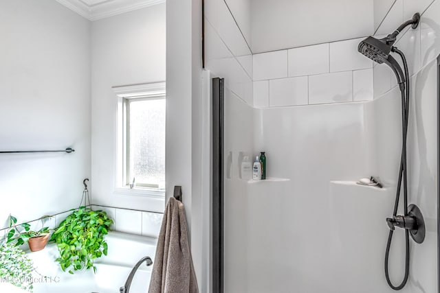 bathroom with crown molding and a shower