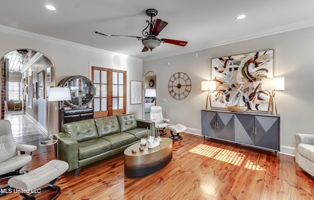 521 Heyward Ln, Madison, MS 39110 - living area with arched walkways, a ceiling fan, baseboards, wood finished floors, and crown molding