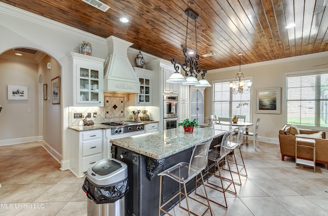 521 Heyward Ln, Madison, MS 39110 - kitchen featuring wood ceiling, appliances with stainless steel finishes, light tile patterned flooring, arched walkways, and ornamental molding