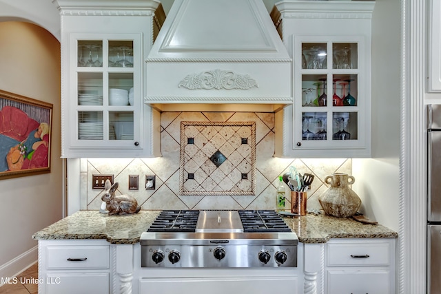 521 Heyward Ln, Madison, MS 39110 - kitchen featuring stainless steel gas stovetop, premium range hood, white cabinets, and glass insert cabinets