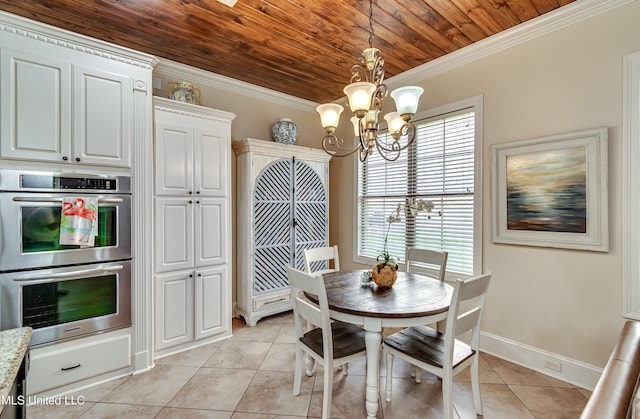 521 Heyward Ln, Madison, MS 39110 - dining room with a chandelier, light tile patterned flooring, wooden ceiling, crown molding, and baseboards