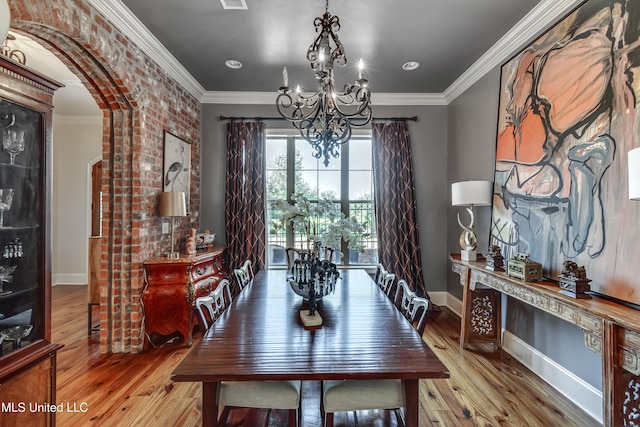 521 Heyward Ln, Madison, MS 39110 - dining area with a chandelier, baseboards, wood finished floors, arched walkways, and crown molding