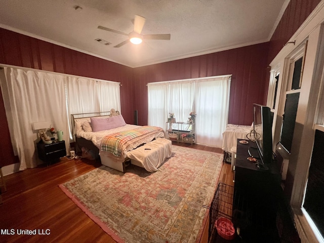 701 Court St, Cleveland, MS 38732 - bedroom with crown molding, ceiling fan, visible vents, and wood finished floors
