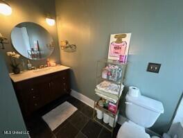 701 Court St, Cleveland, MS 38732 - bathroom with vanity, baseboards, and toilet
