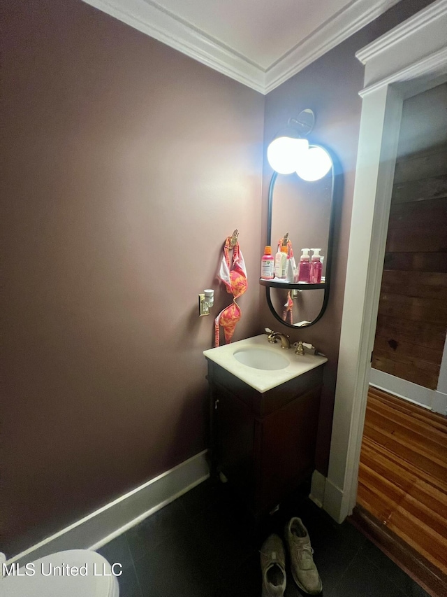 701 Court St, Cleveland, MS 38732 - bathroom featuring vanity, ornamental molding, and baseboards