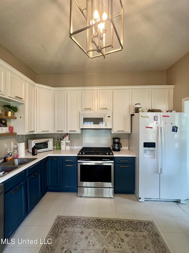 701 Court St, Cleveland, MS 38732 - kitchen featuring light countertops, a sink, white appliances, and blue cabinetry